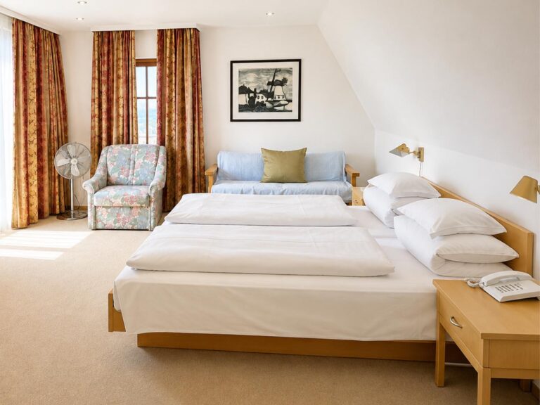 Bright Apartment under the sloping ceiling with a double bed, bench seat and armchair